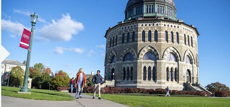 Students walking across campus with the Nott Memorial visible in the background